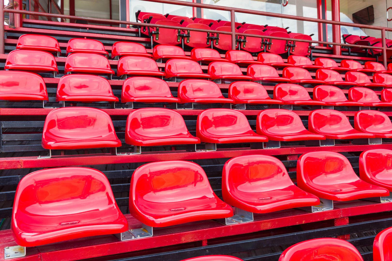 A stadium with red seats and black stands.